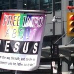 A street ministry speaking to Jesus saving souls via a multicolor display.